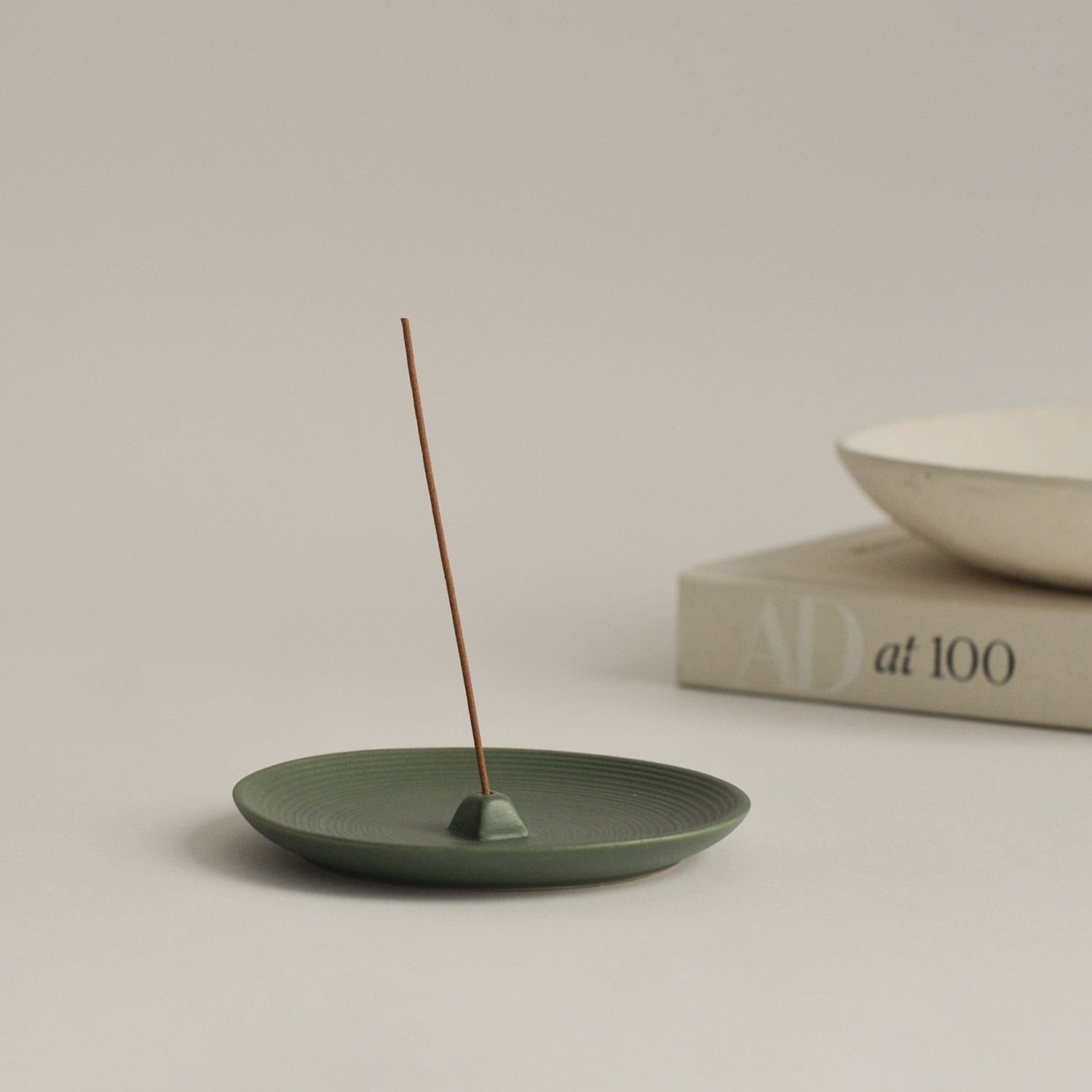 Green Ceramic Incense Holder Plate with book in background