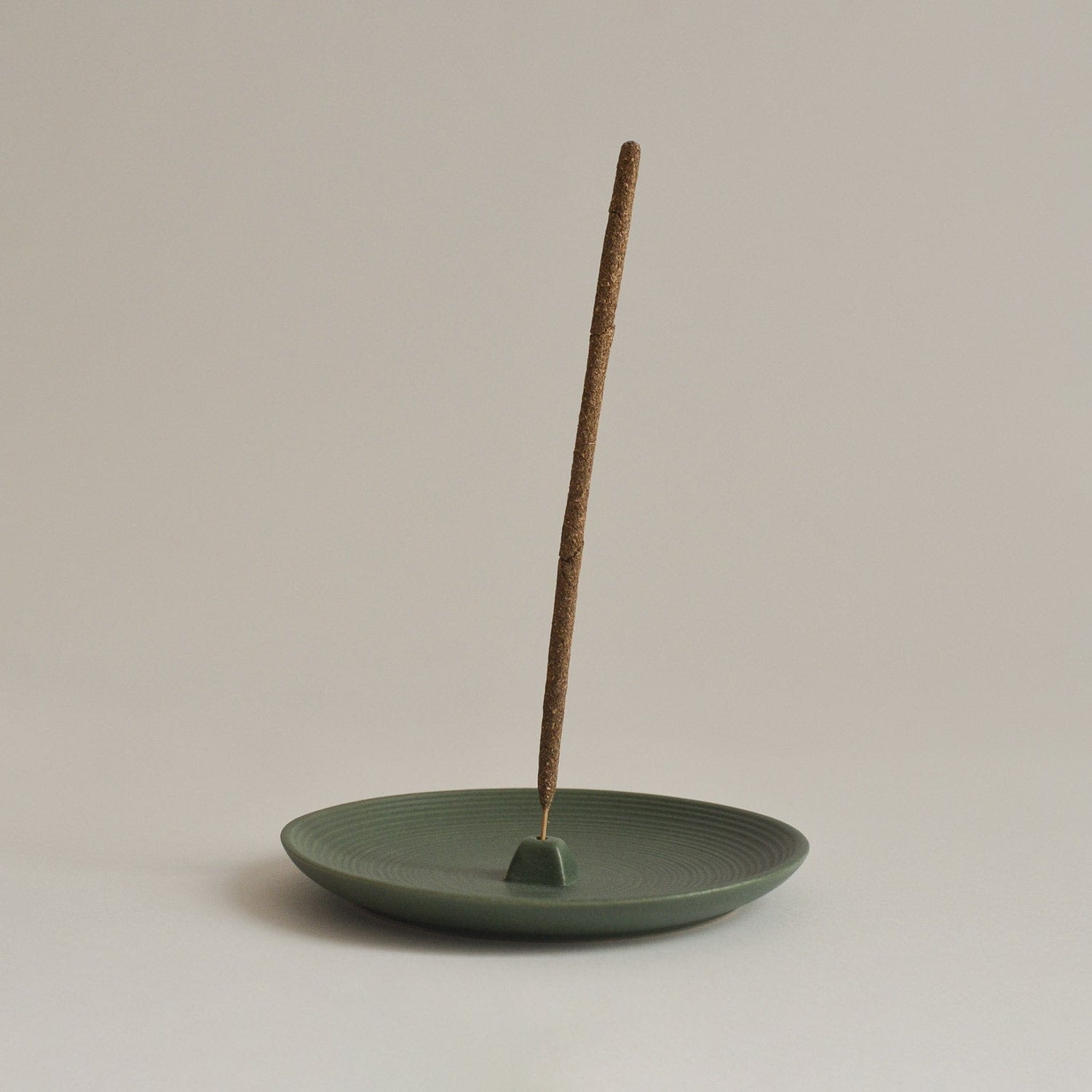 Green Ceramic Incense Holder Plate on beige background