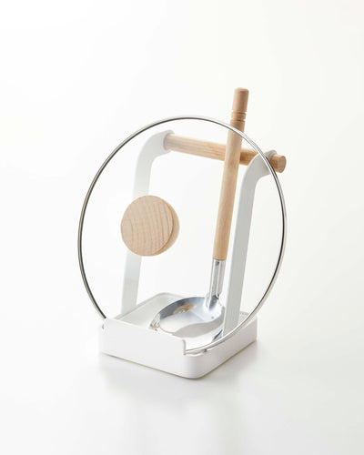 Glass stand with wooden and metal components on a white background
