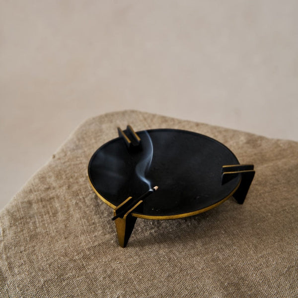 A vintage-inspired Milan Ashtray crafted from solid brass with a sleek black patina, displayed on a neutral background.