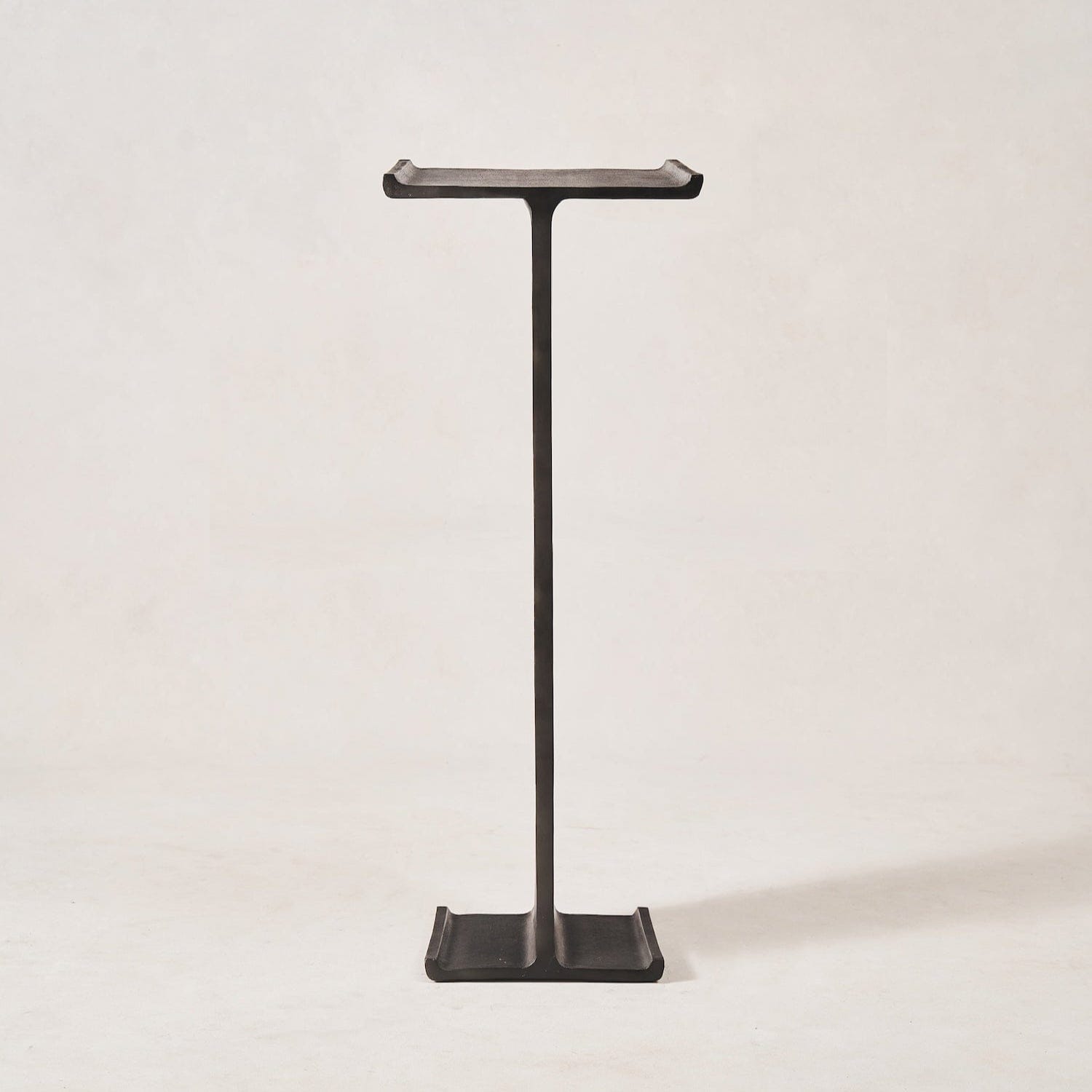 Tall aluminum pedestal stand with architectural silhouette