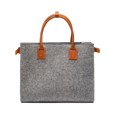 Kyrgies Handmade Wool Handbag, charcoal wool felt, close-up interior view showing leather handle attachment