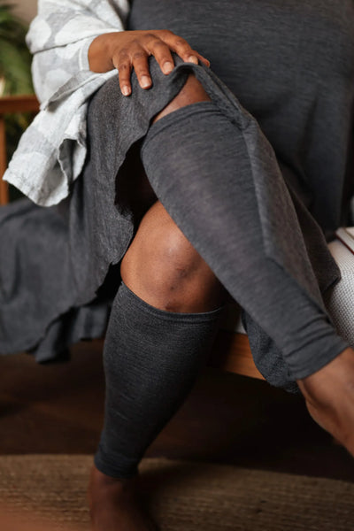 Woman wearing merino wool leg warmers showcasing soft natural wool comfort and flexible everyday styling.