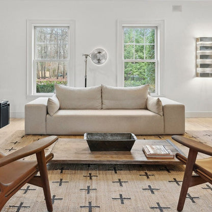 Ojai linen sofa styled in airy living room with wood coffee table