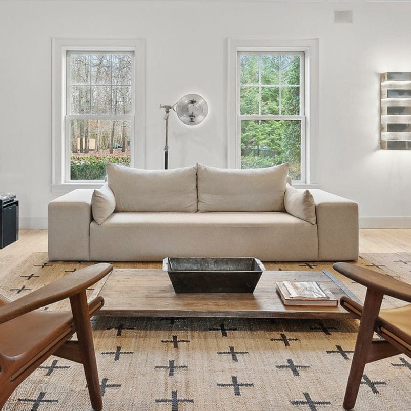 Ojai linen sofa styled in airy living room with wood coffee table