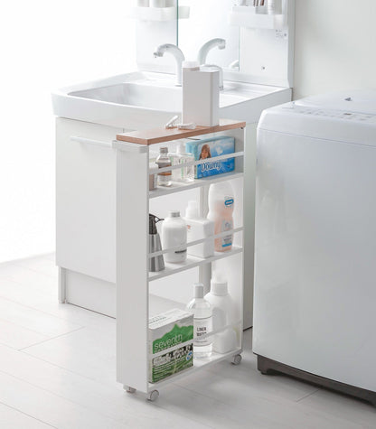 White rolling cart with shelves in a bathroom setting. Slim Storage Cart (32&quot; H)  - Steel shown in laundry room