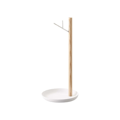 Empty Yamazaki Home Banana Stand - Steel + Wood isolated on white, showing a slender wooden post set near the edge of a round white base and a short upward-angled metal hook.