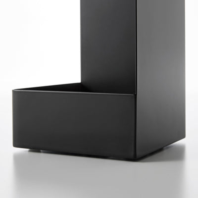 Detail of the black Yamazaki Home Rolling Bathroom Organizer - Steel base, showing the deep lower tray, raised front wall and smooth vertical side panel.