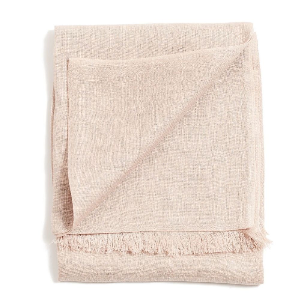 Folded blush-pink color variation of the Variously handwoven scarf with a delicate weave and short fringe