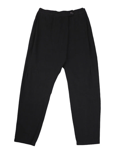 Front product view of black Canvas Souk pants with a buttoned waistband and tapered legs.