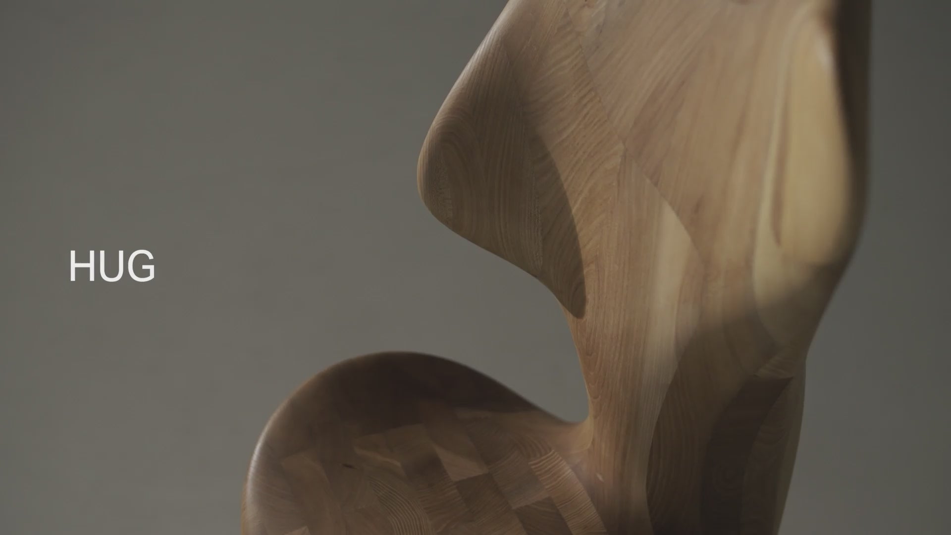 Load video: Designer Xu Yuhao presenting the HUG Chair by CondeHouse, a sculptural Japandi chair crafted in Japanese Elm Natural