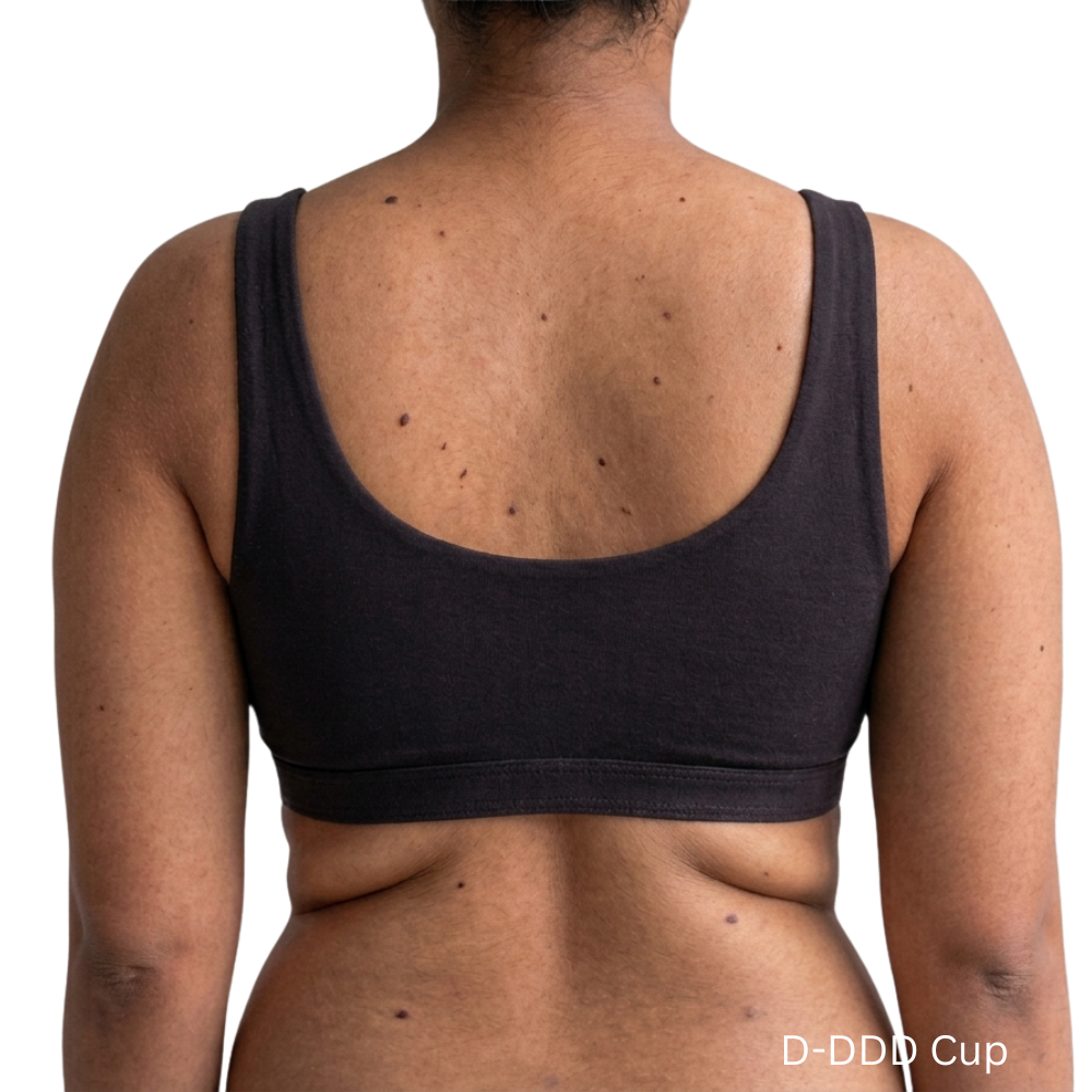 Back view of model wearing PROCLAIM Organic Cotton Everyday Bralette in Black, D-DDD cup
