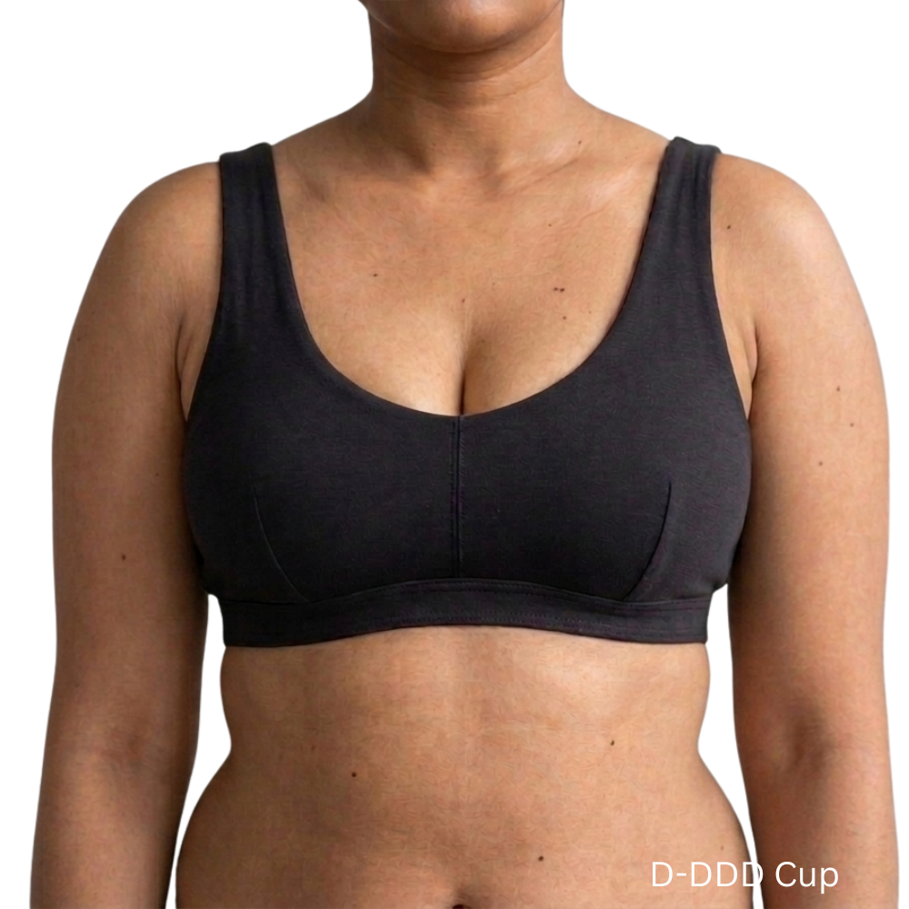 Model wearing PROCLAIM Organic Cotton Everyday Bralette in Black, D-DDD cup, front view