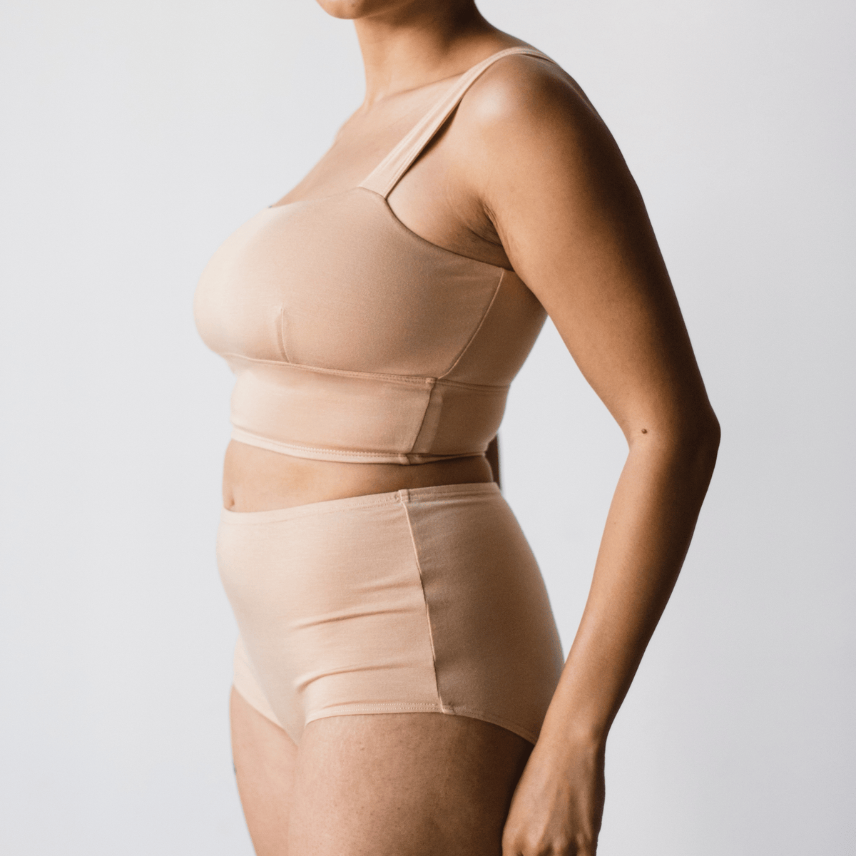Side view of model wearing PROCLAIM Organic Cotton Square Neck Bralette in Ada Nude