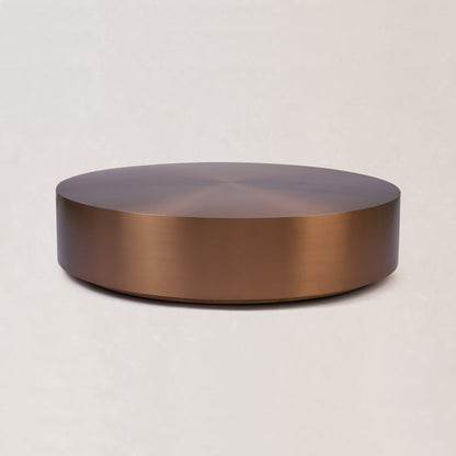 Round copper coffee table with low profile and brushed copper surface