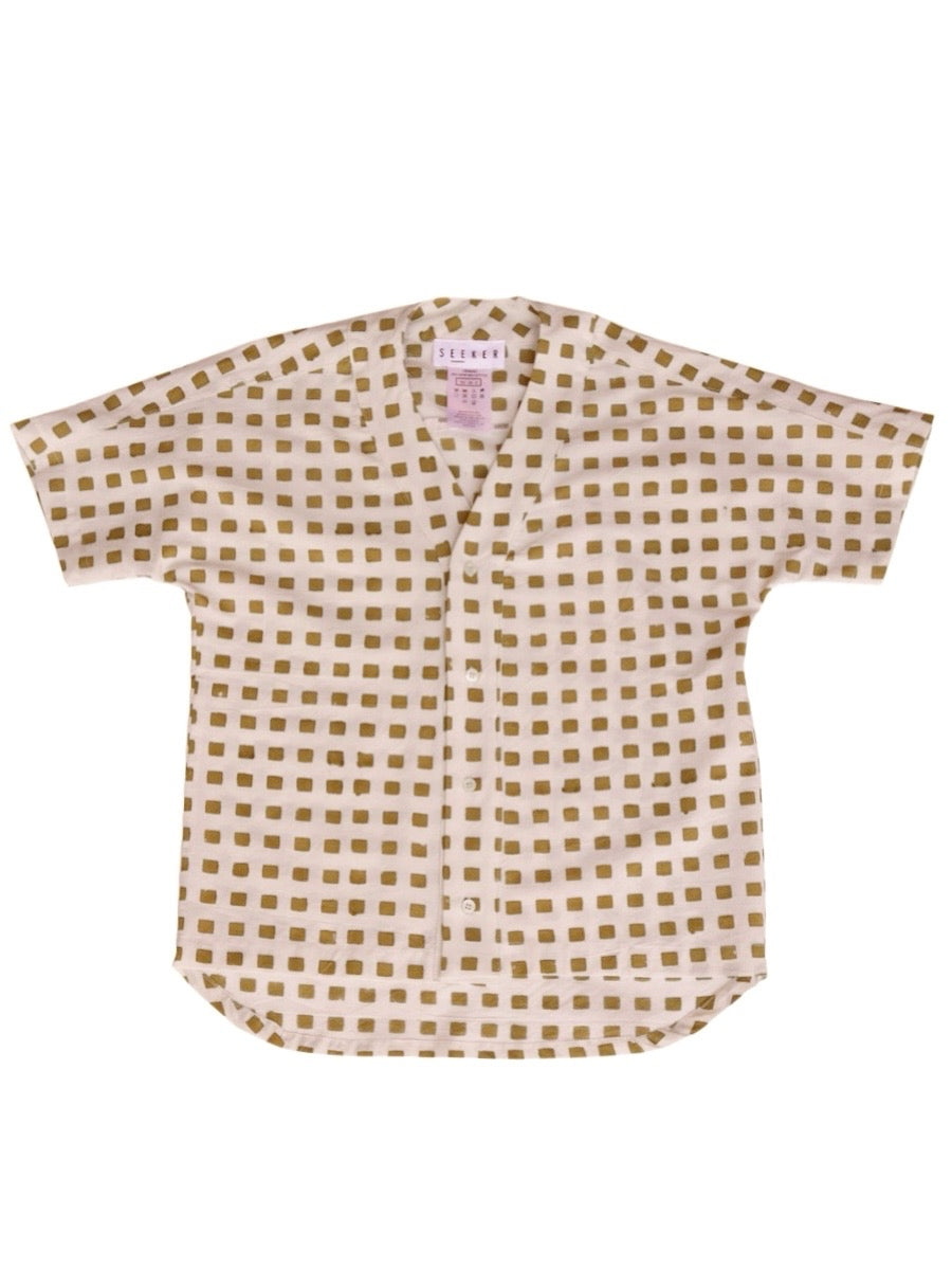 Front product view of the cream baseball shirt with ochre hand-block-printed squares.
