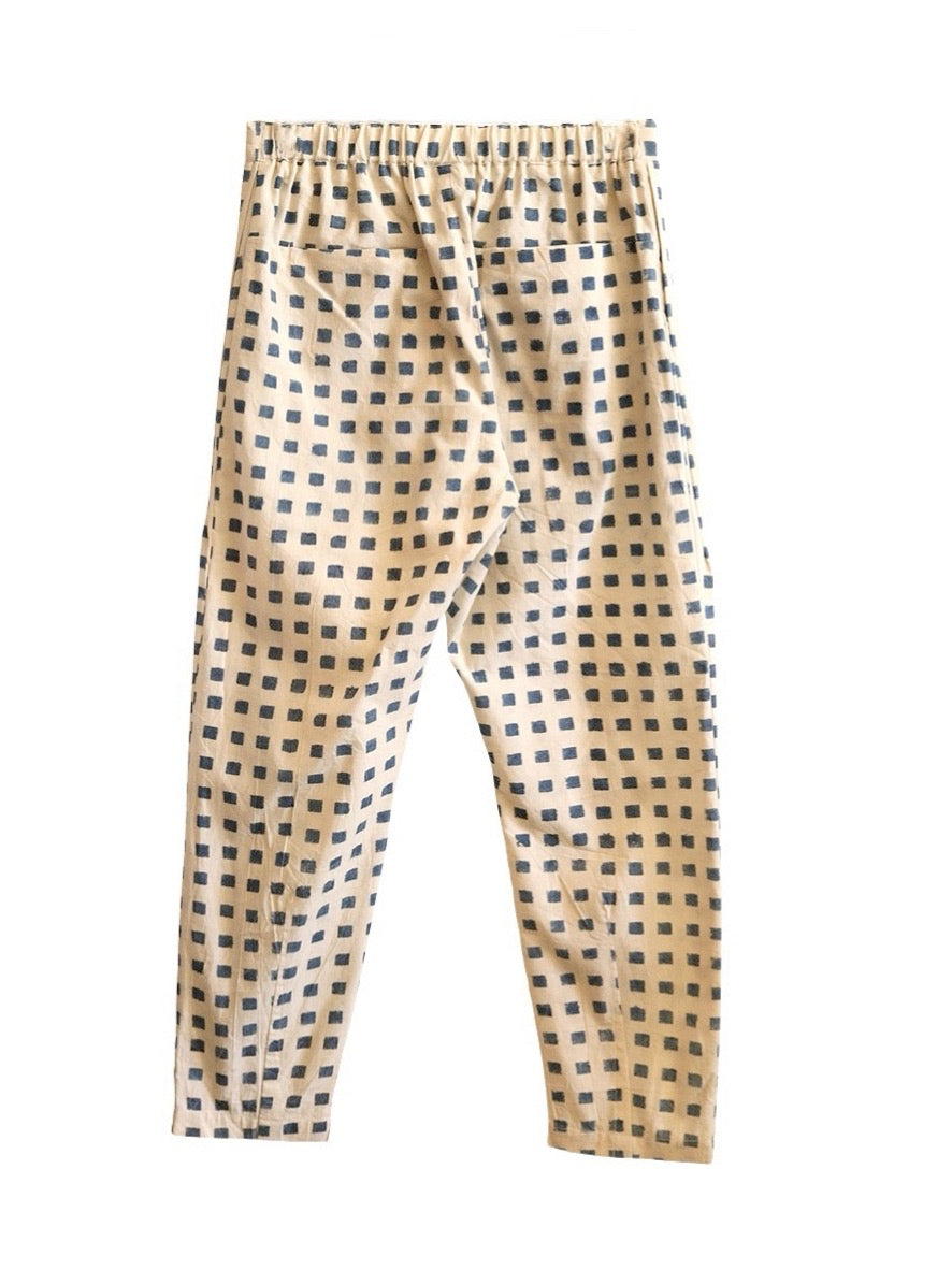 Back product view of cream Souk pants with indigo squares and an elastic waistband.