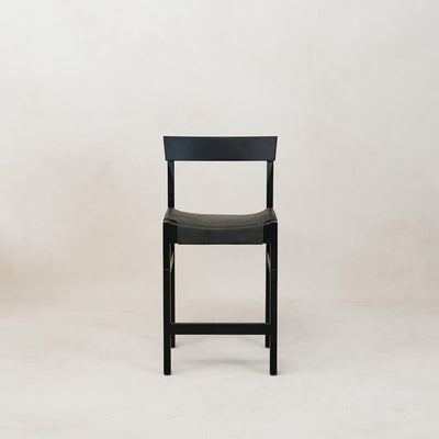 A black Shinto counter stool with a leather seat and wooden frame, displayed against a neutral background.