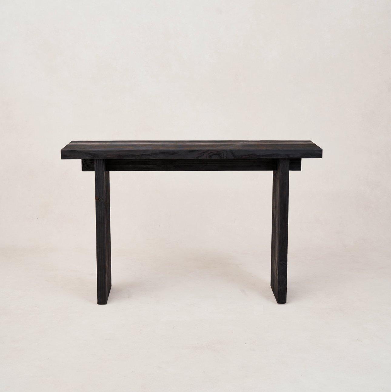A black Shou Sugi Ban entry console made of wood, displayed against a neutral background.