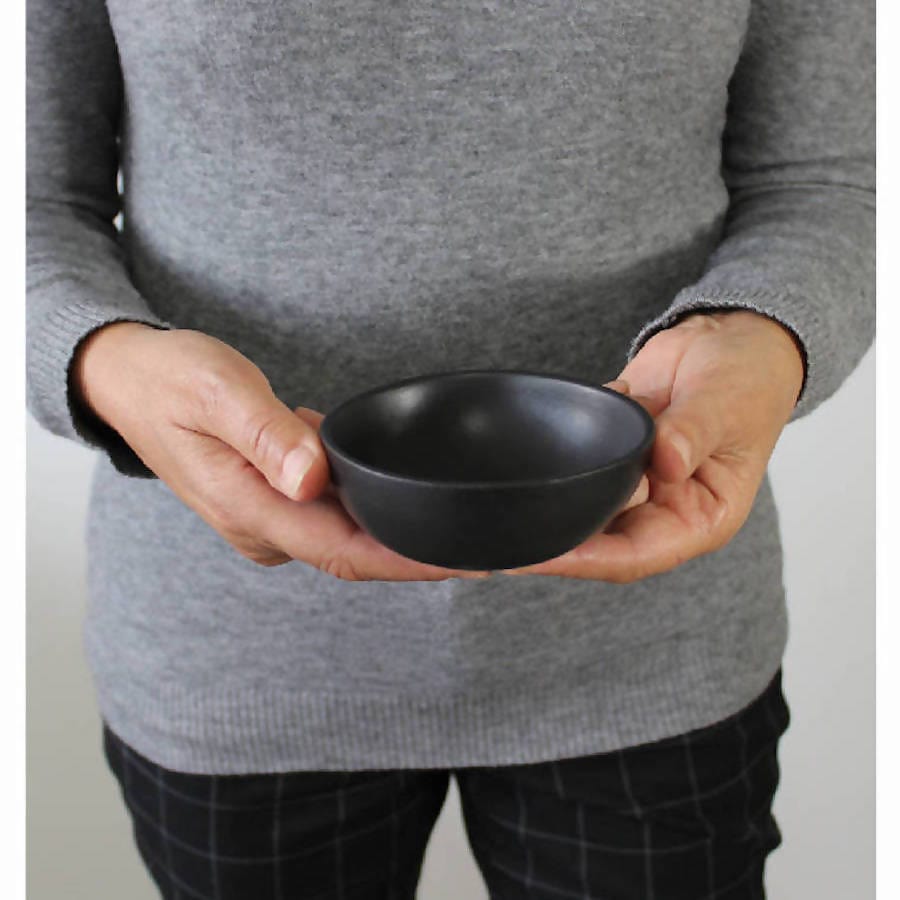 Gharyan Stoneware Japandi Tableware Condiment Bowl, black, held by person for scale