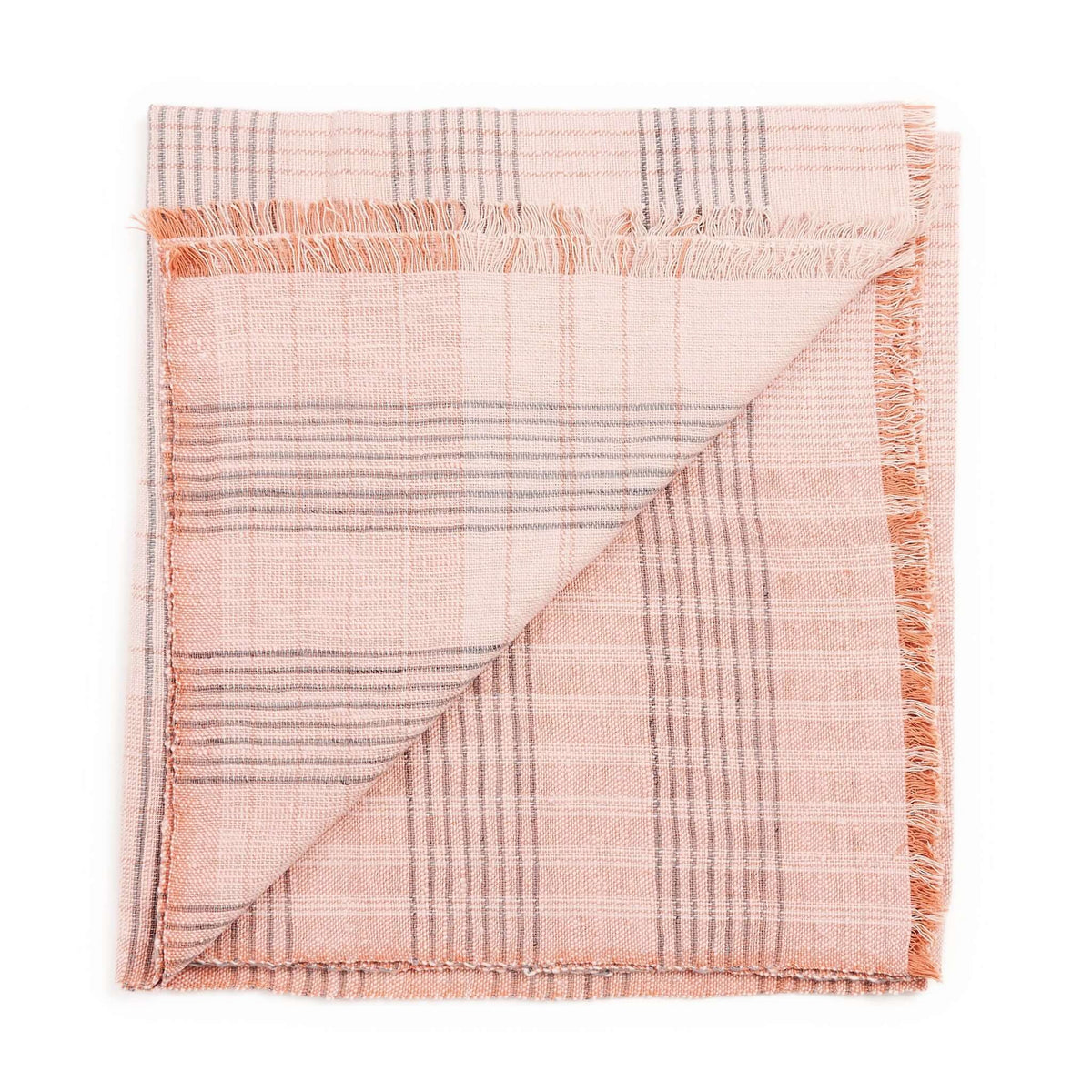 Folded blush-pink color variation of the Variously striped handwoven throw with fine woven lines and fringe