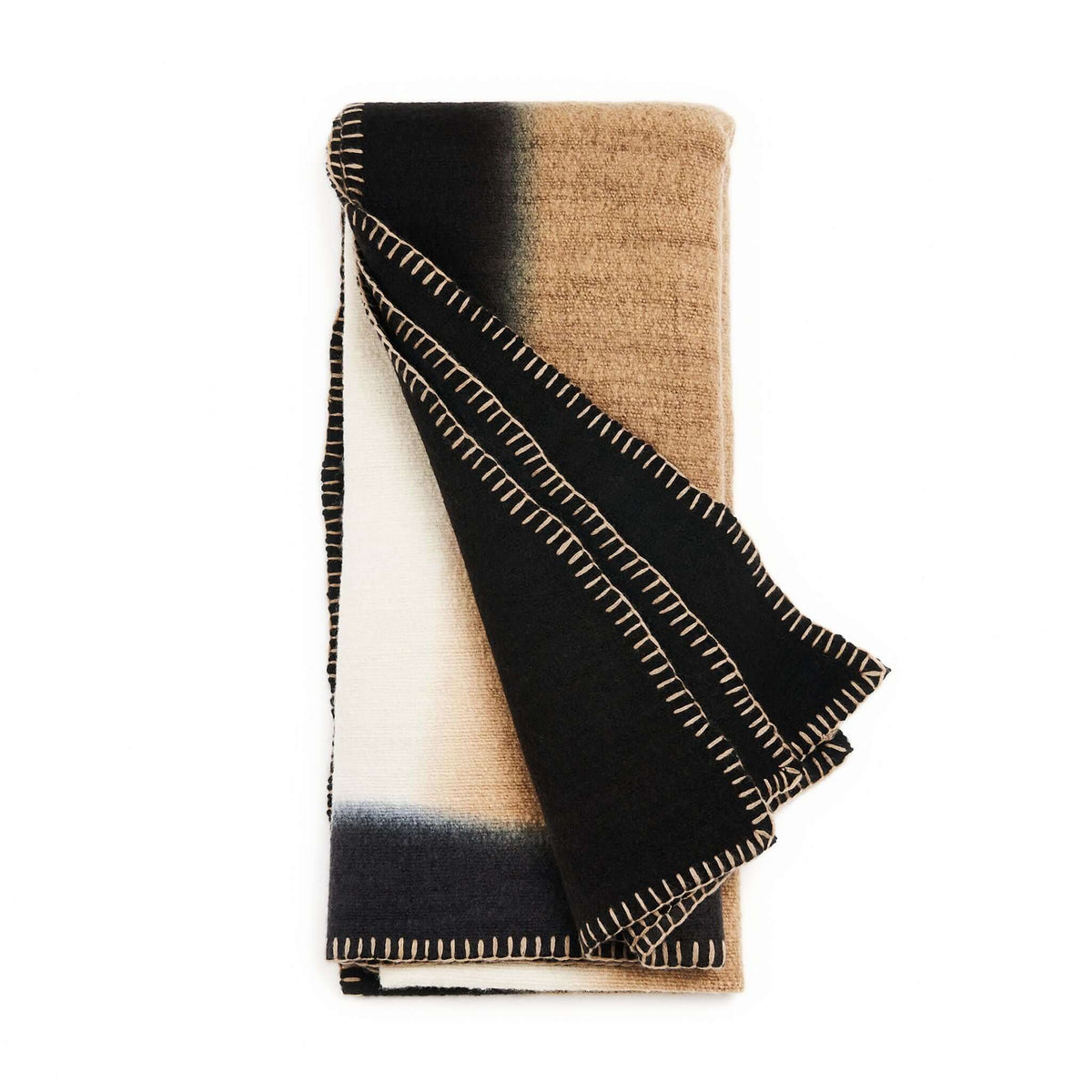 Variously Siro Brown merino throw folded to reveal warm tan, cream and black color blocks with contrasting hand-stitched edges