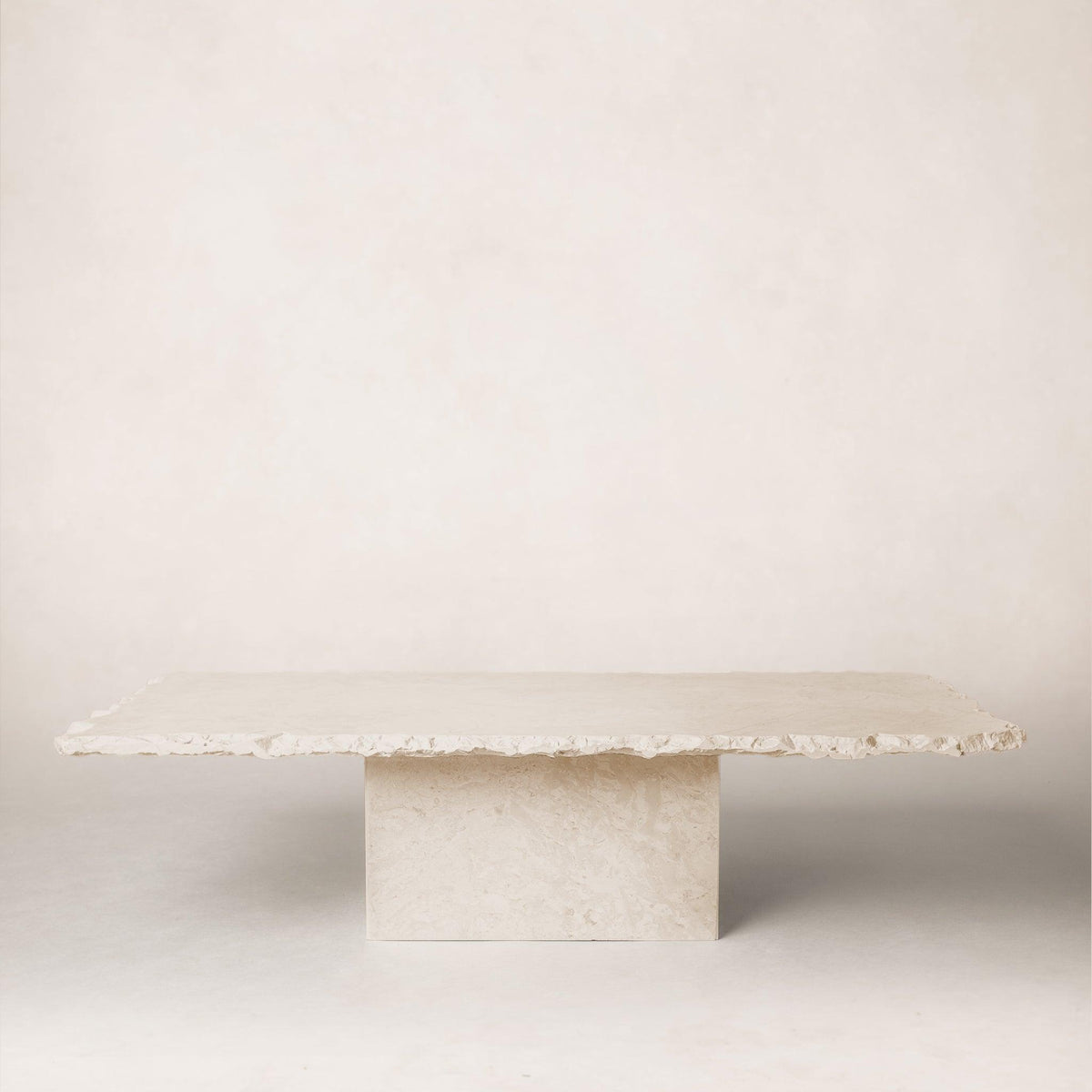 Sofita marble coffee table with minimal veining and sculptural pedestal base
