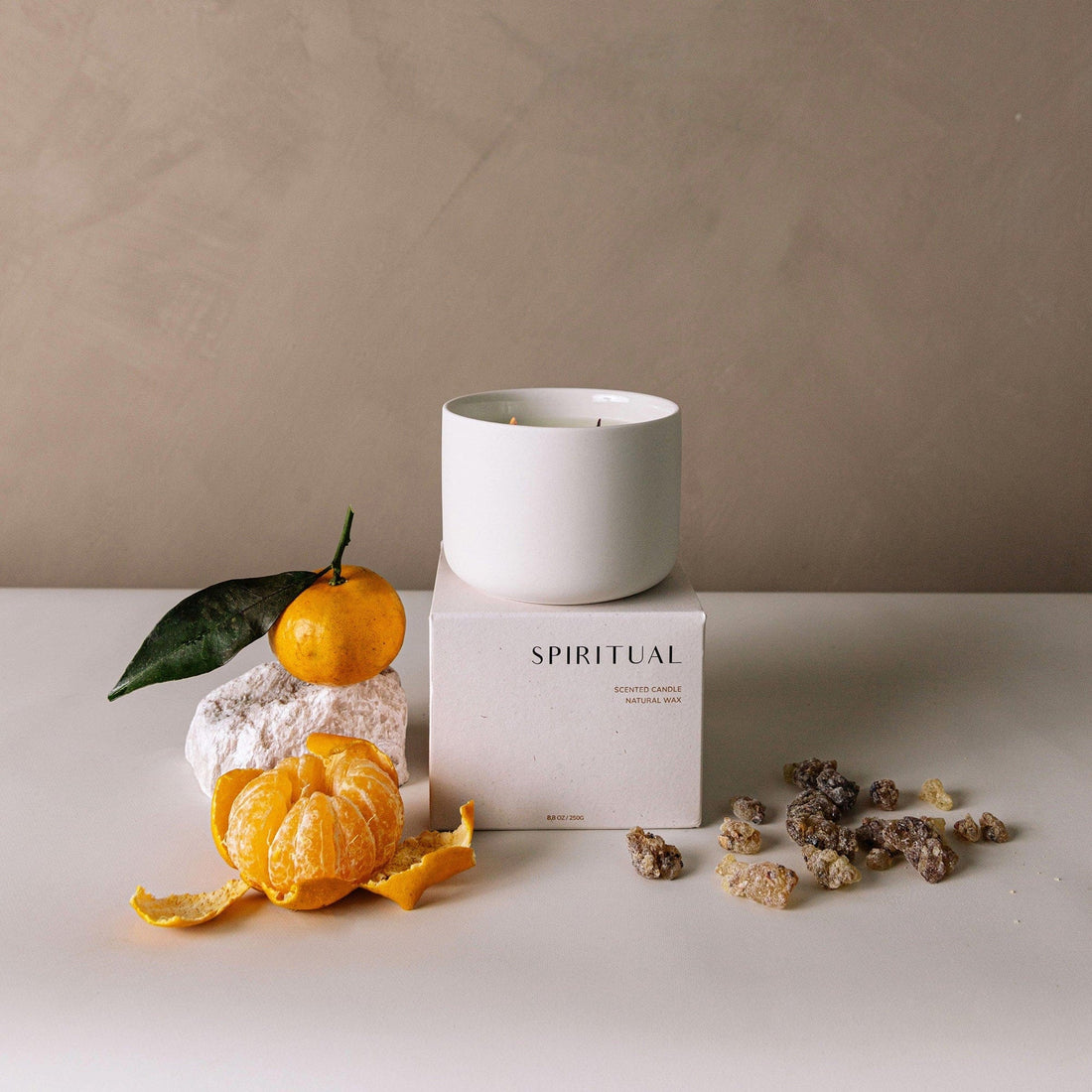 White candle on a box labeled &
