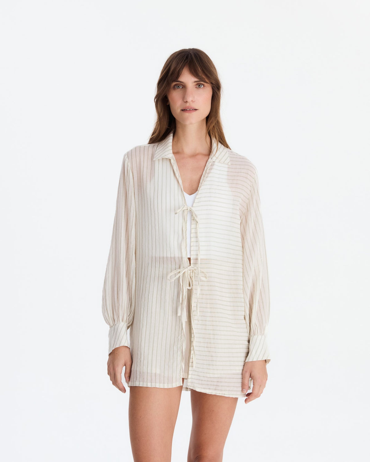 Front view of the tied cover-up, showing contrasting horizontal and vertical stripe panels, cuffed sleeves, and an upper-thigh-length hem.