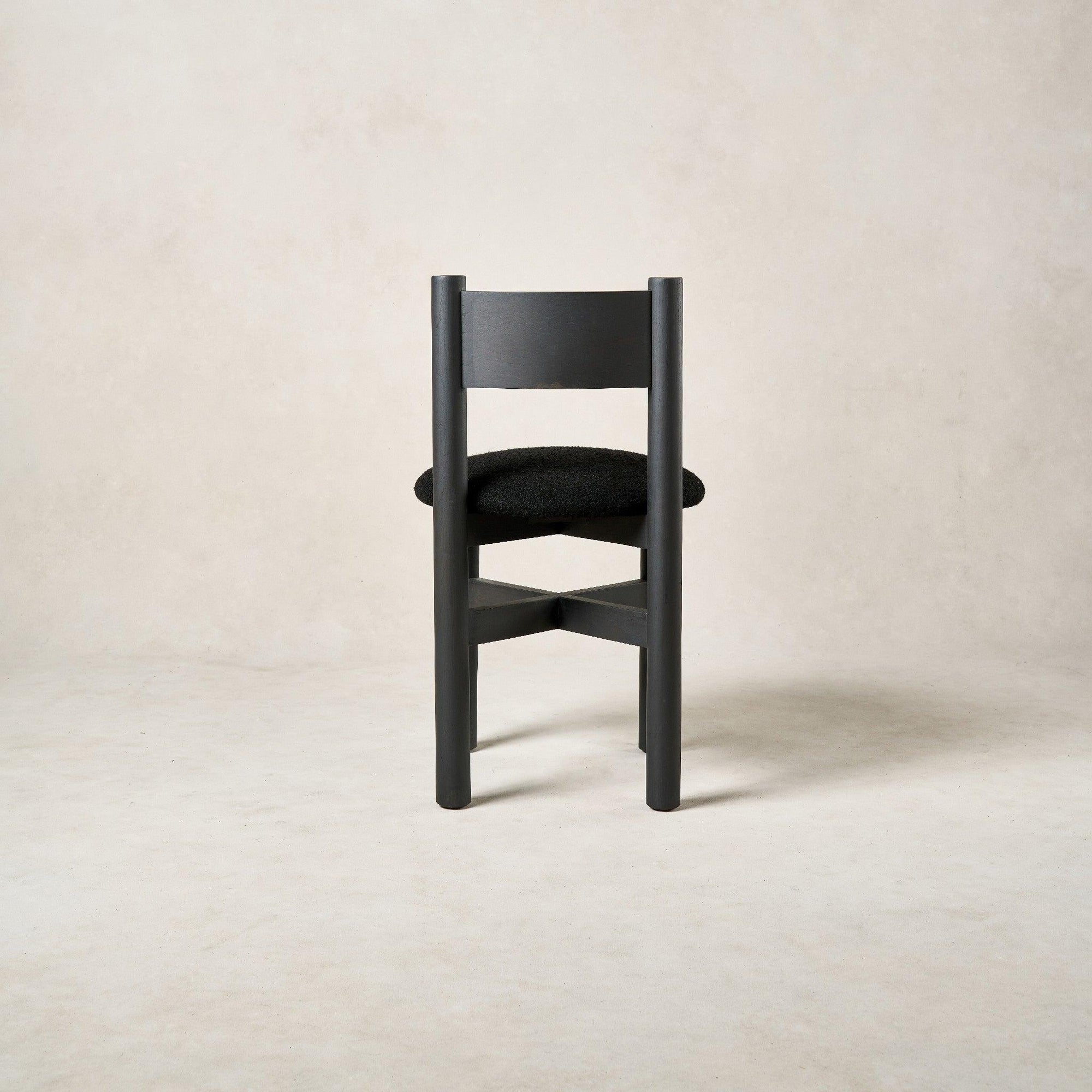 Back view of Teddy dining chair in black with rounded white oak backrest