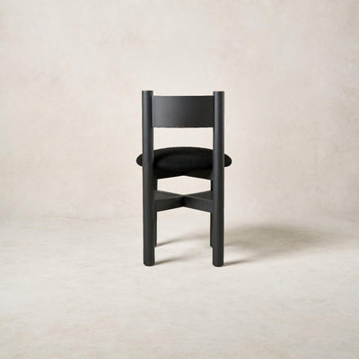 Back view of Teddy dining chair in black with rounded white oak backrest