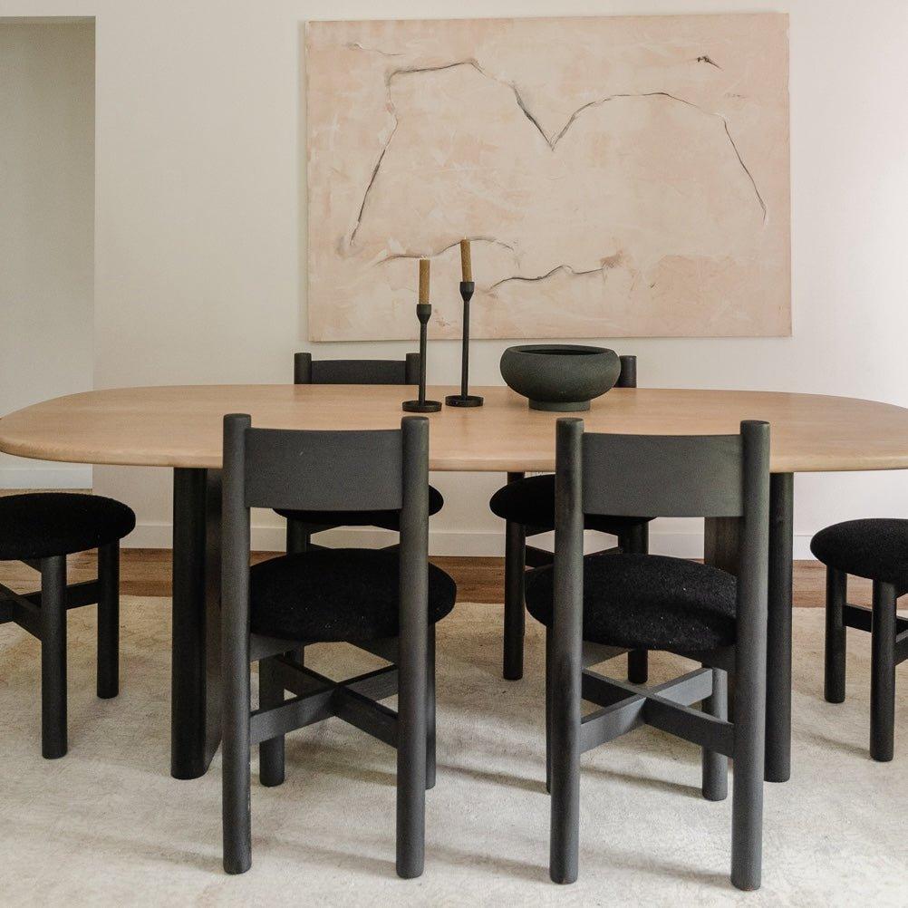 Teddy black dining chairs paired with solid wood dining table in Japandi interior