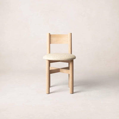 A single Teddy dining chair with a natural wood frame and beige upholstered seat, displayed against a neutral background.