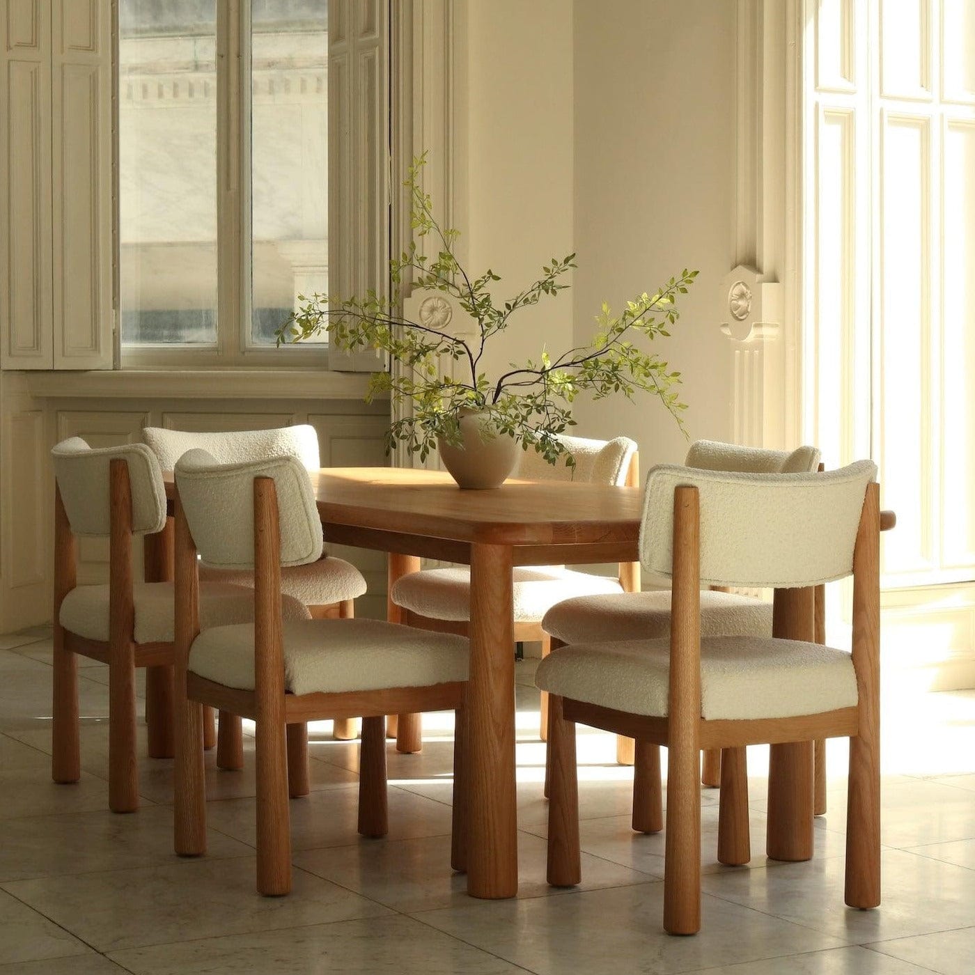 Charlie dining chair in white oak with bouclé upholstery, styled dining room setting