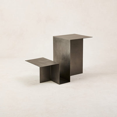 Hand-finished metal side table with soft reflective surface