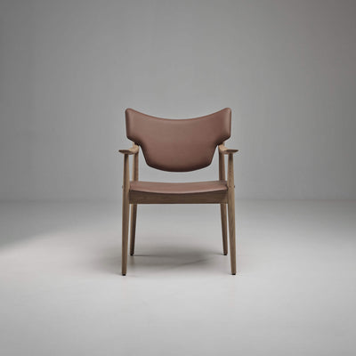 Front view of the taupe-brown Eikund Veng Arm Chair with a light brown wood frame, showing the curved backrest, narrow padded seat, and sculpted armrests.