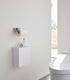 Modern bathroom with a toilet and wall-mounted cabinet. Wall-Mounted Storage or Trash Bin shown on wall.