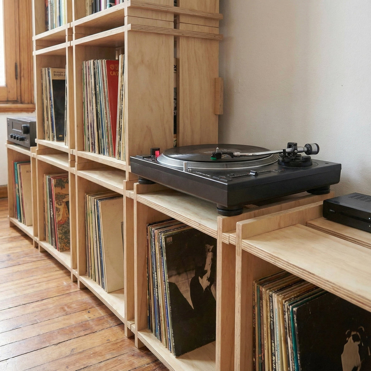 Close-up of Williamsburg Cubical record storage units holding vinyl albums with a black turntable positioned on top