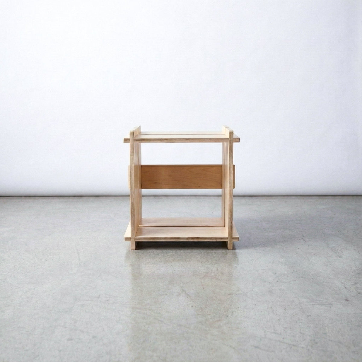 Straight-on view of an empty Williamsburg Cubical natural wood storage unit against a plain studio background