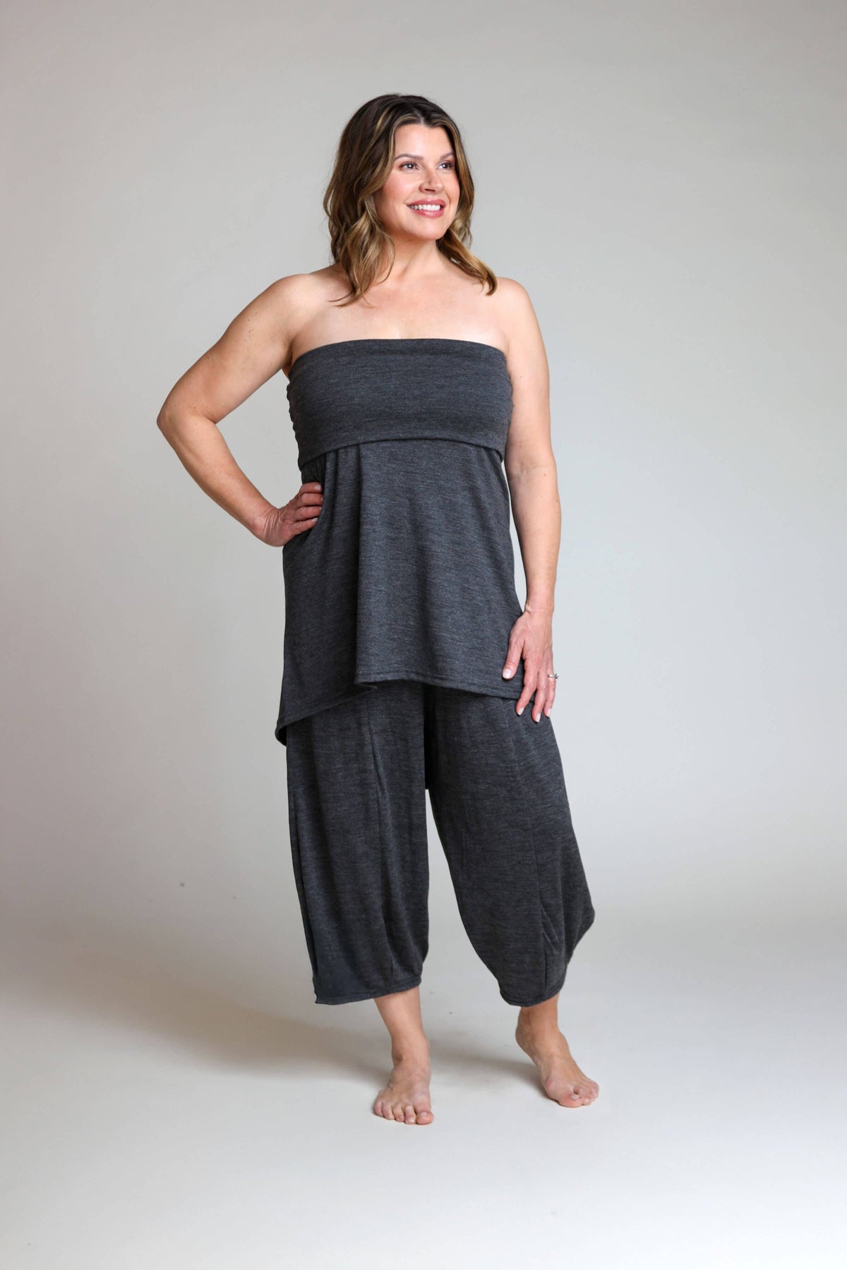 Convertible merino wool dress styled as a layered tunic with lounge pants for travel, recovery, and everyday comfort.