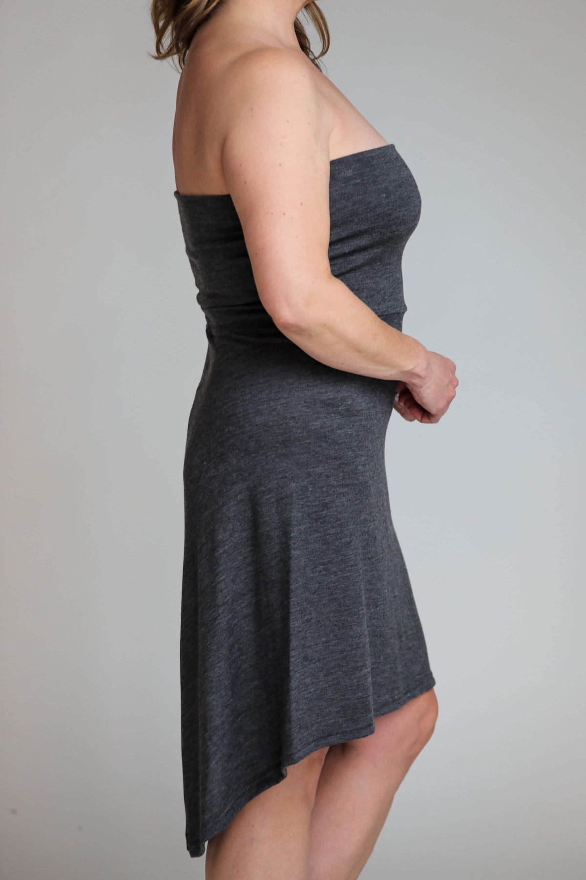 Side detail of the convertible merino wool dress highlighting natural stretch, breathable comfort, and elegant drape.