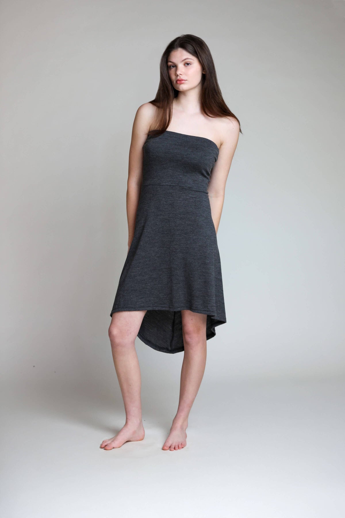 Convertible merino wool dress worn as a strapless dress featuring a relaxed silhouette and breathable natural wool fabric.