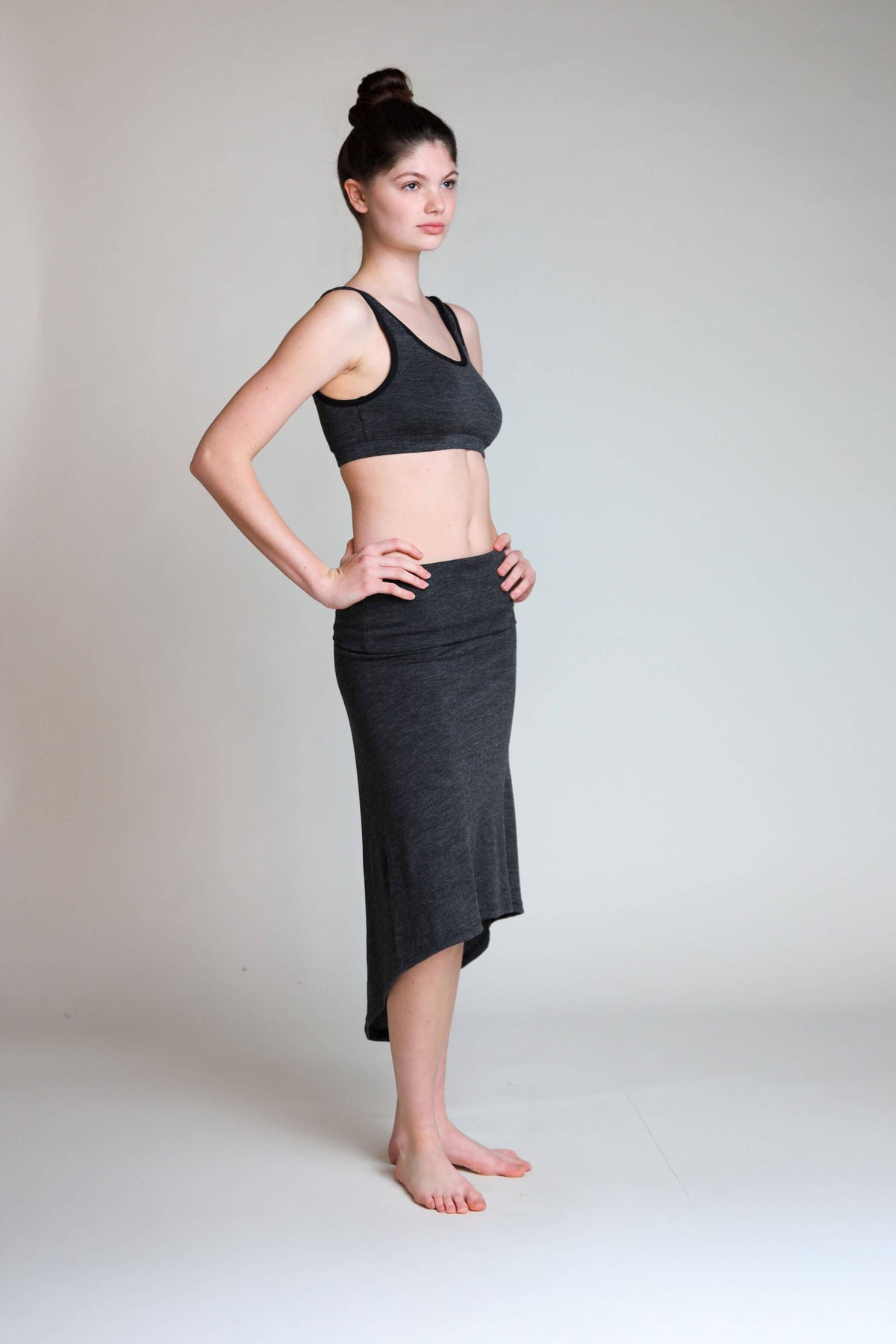 Side view of the convertible merino wool dress highlighting its flowing shape and versatile fit.