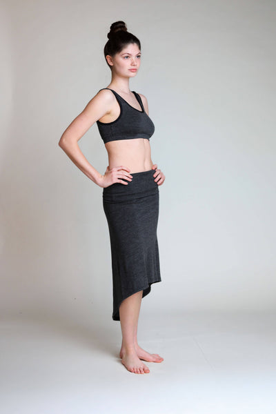 Side view of the convertible merino wool dress highlighting its flowing shape and versatile fit.