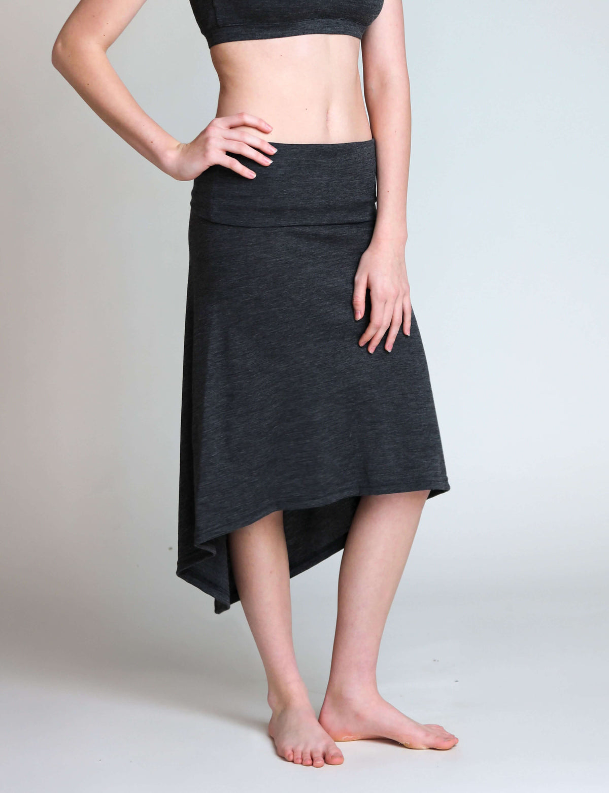 Convertible merino wool piece worn as a skirt, demonstrating its multifunctional design and flexible coverage.