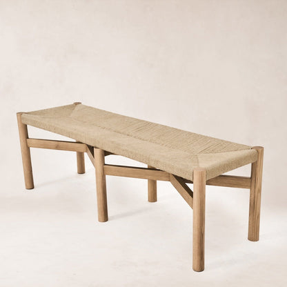 Angled view of Nonna bench showing woven seat and oak legs