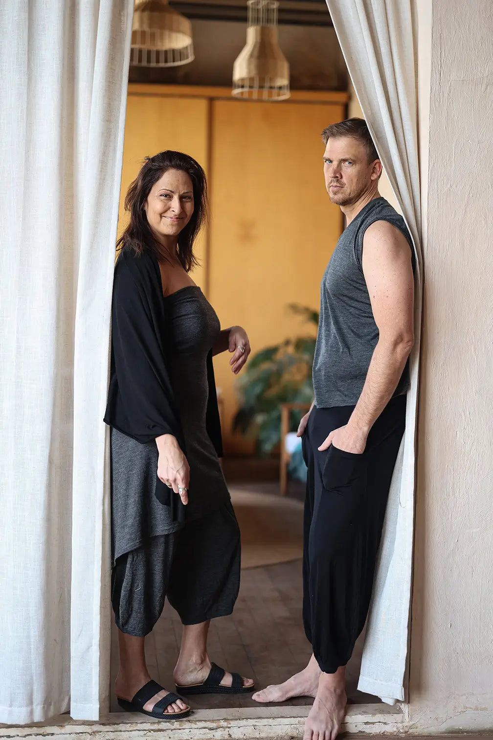Men and women wearing merino wool pocket wraps and lounge pieces inspired by sauna culture and intentional living.