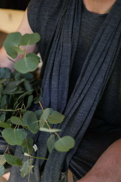 Close-up of charcoal merino wool pocket wrap fabric showing soft texture, natural drape, and timeless minimalist styling.