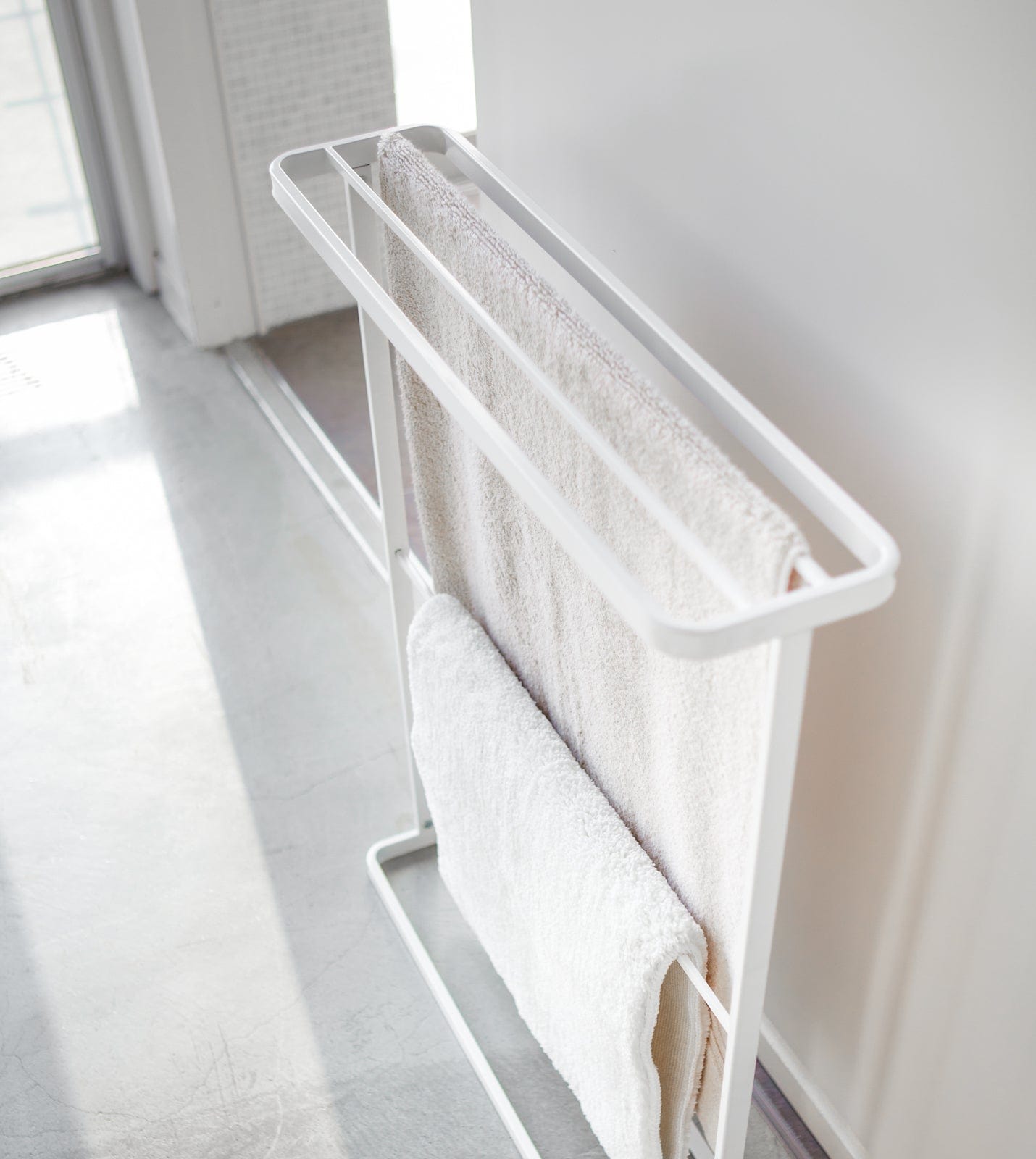 Towel rack with white towels in a bright room. Bath Towel Hanger (30" H)  - Steel