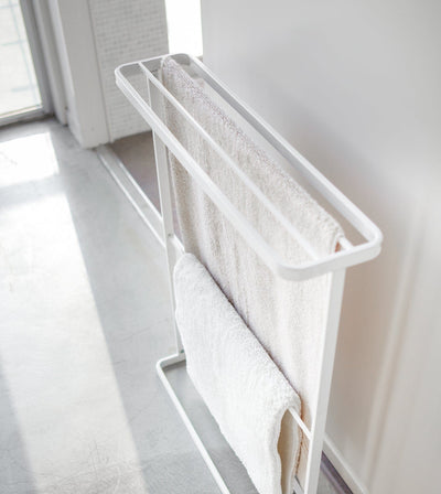 Towel rack with white towels in a bright room. Bath Towel Hanger (30" H)  - Steel